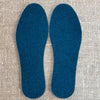 A pair of Poddy and Black wool felt insoles in Teal